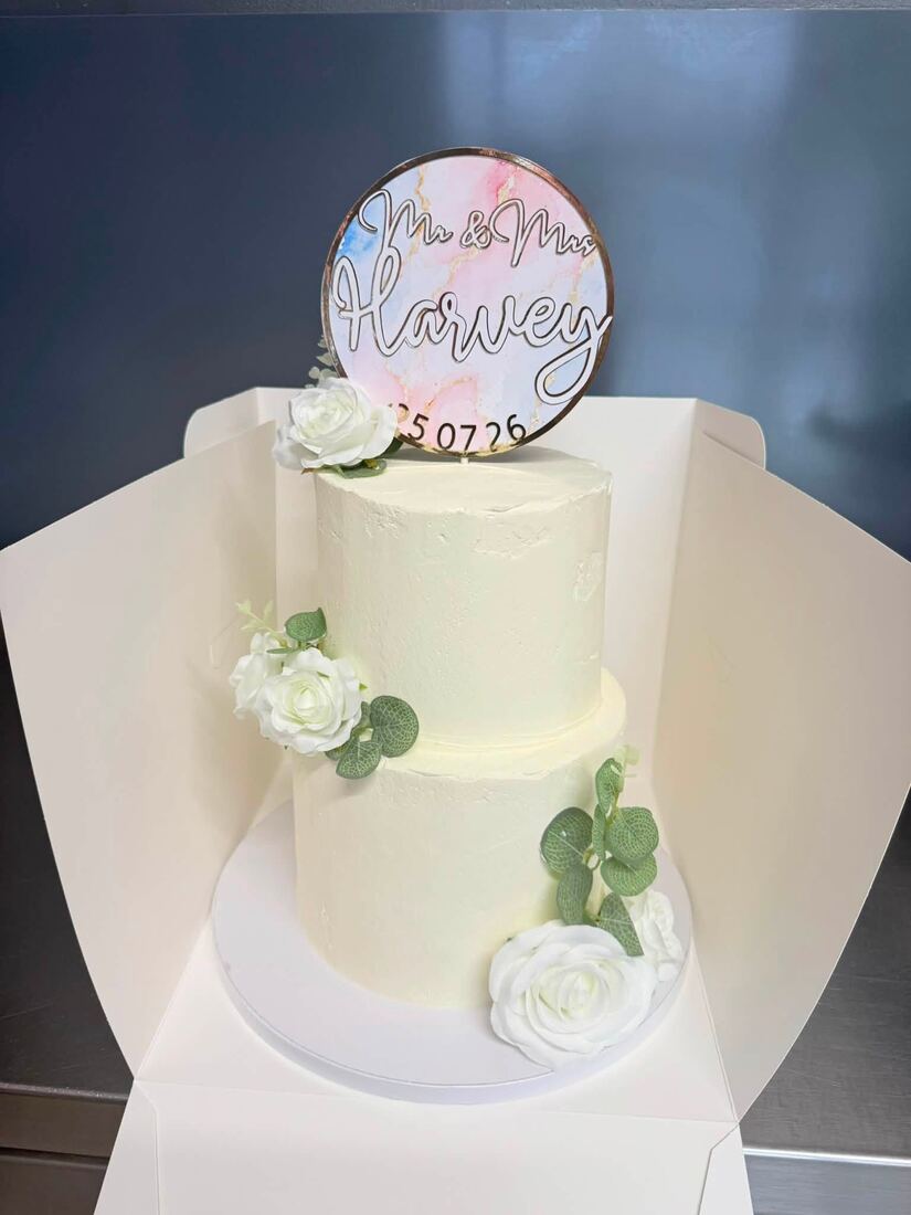Pink third-birthday cake decorated with cartoon dog characters and a pastel rainbow