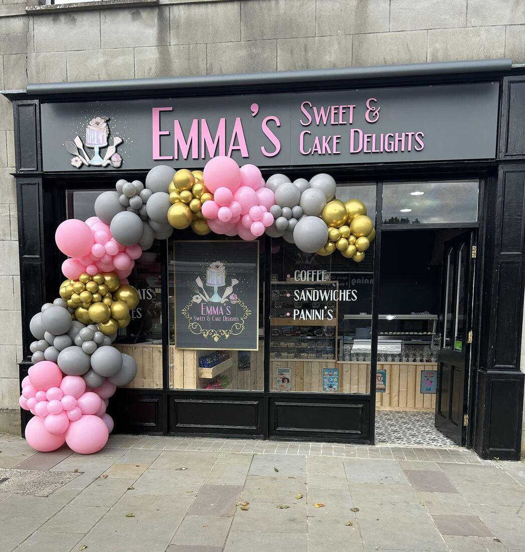 Emma's Sweet & Cake Delights shopfront in Comber with a pink, grey and gold balloon arch